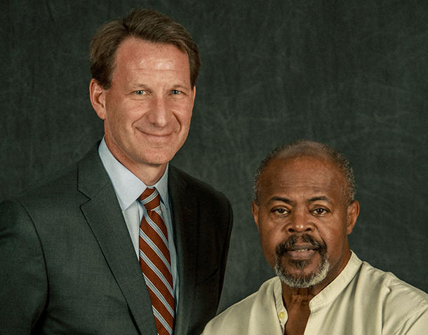 Dr. Sharpless and a former patient, Mike together in a photo studio with a dark backdrop
