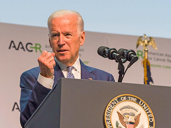 VP Biden speaks at a lectern with the Presidential seal