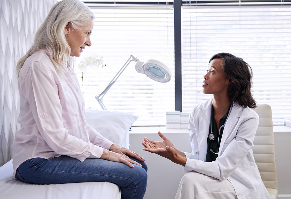 Mature woman in consultation with female doctor