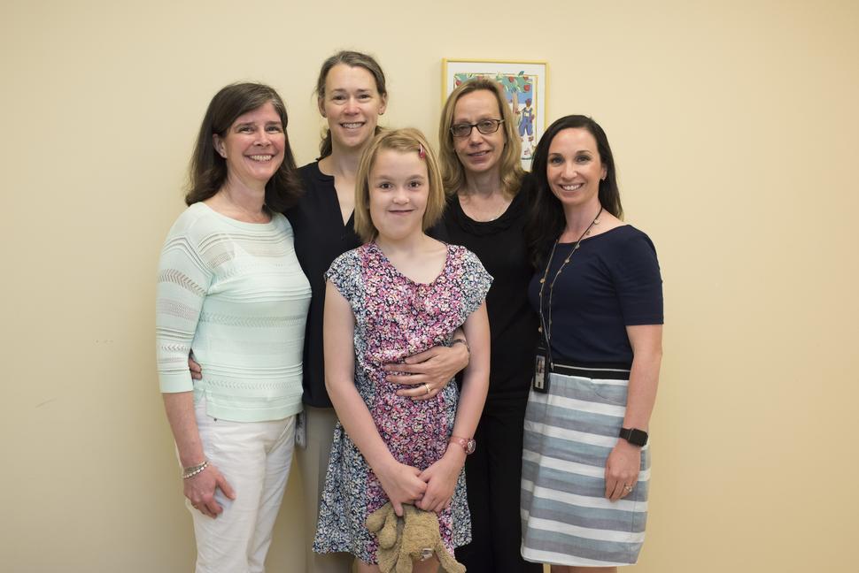Members of the Pediatric Oncology Branch at the National Cancer Institute's Center for Cancer Research (CCR) gather with their young patient Jane and Jane's mother Kristina. Jane received treatment at CCR for a rare cancer called neurofibromatosis type 1 (NF1). Shown from left to right: Trish Whitcomb, RN; Kristina; Jane; Brigitte Widemann, M.D. (branch chief); and Andrea Baldwin, CRNP.