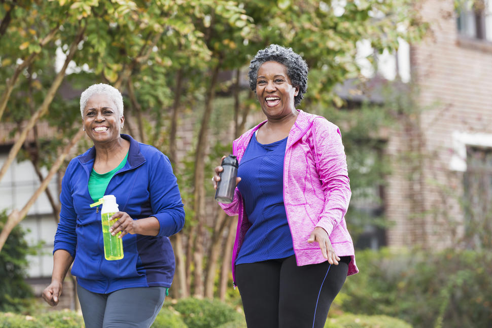 Two older Black women walking on a fall day.