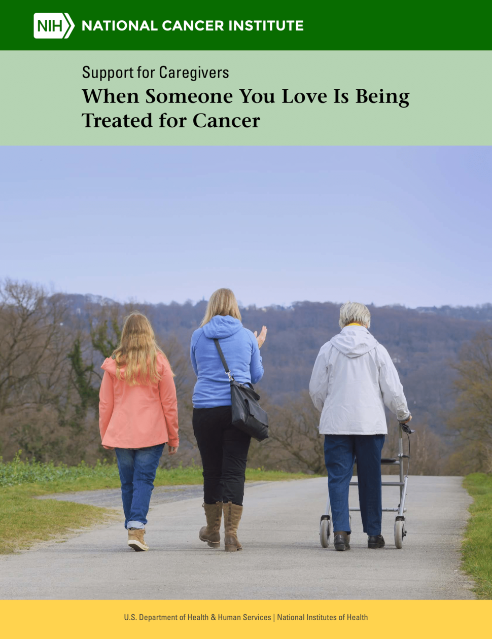 Cover of the “Support for Caregivers: When Someone You Love Is Being Treated For Cancer” by the National Cancer Institute. The background shows three women of different ages - a child, an adult, and an elderly adult with a walker - walking together down a path. The color of the trees in the background indicates the fall season.