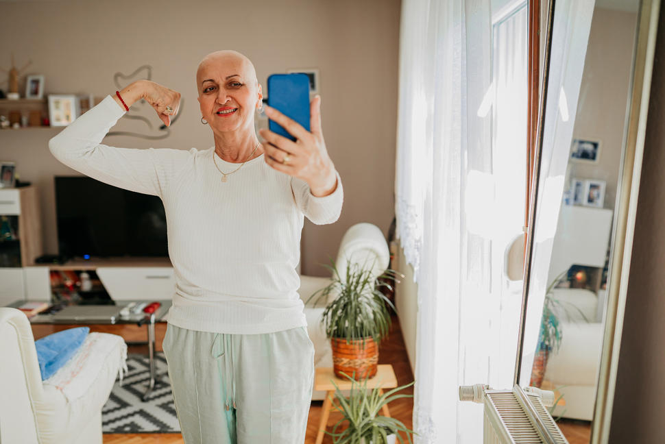 woman flexing her arm muscle taking a selfie