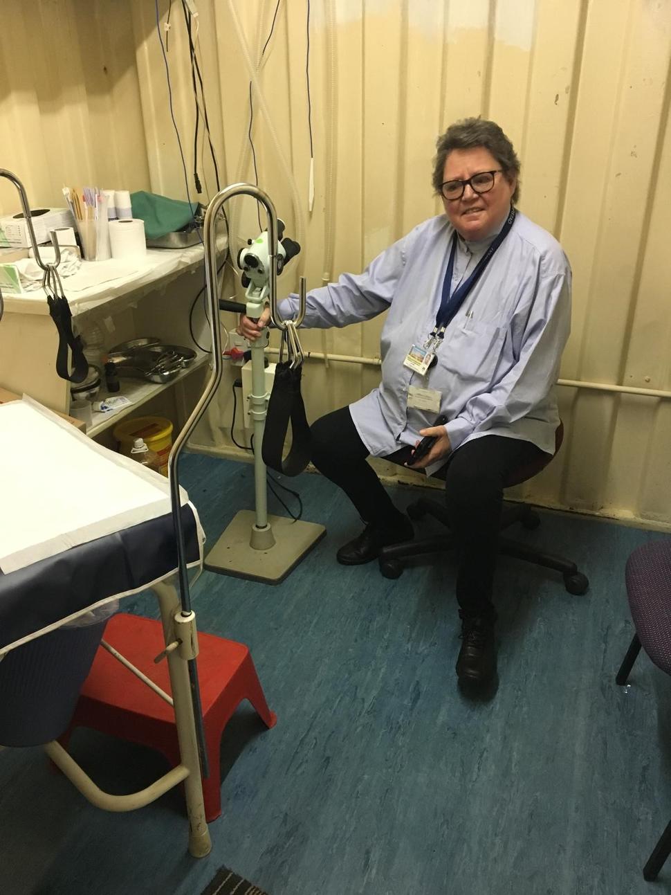 Professor Lynette Denny sitting on a chair in a clinic