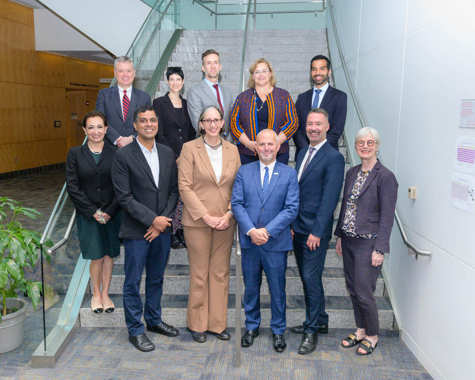 Group of WHO and NCI colleagues standing together on a set of stairs 