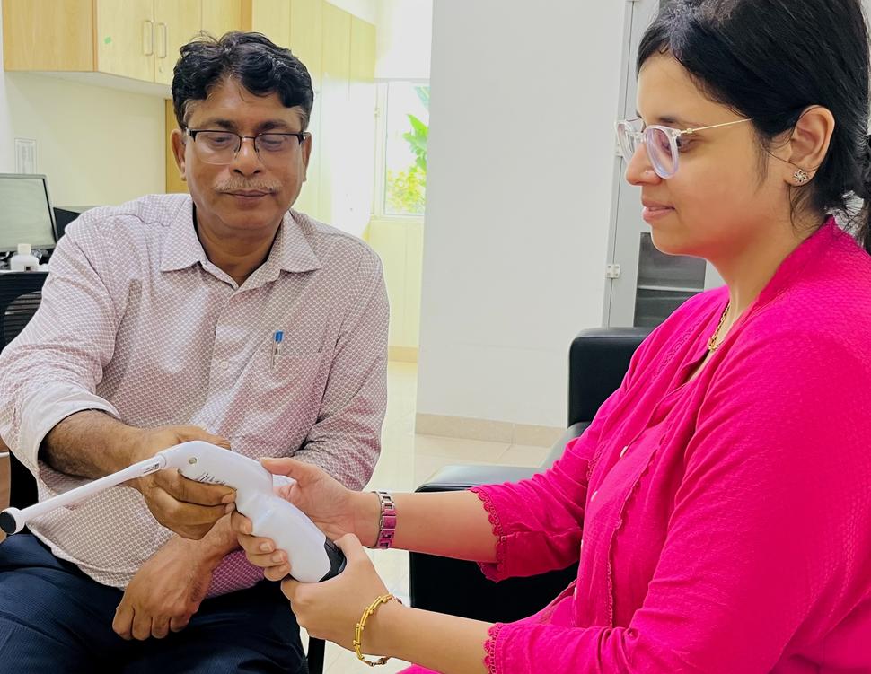 A man and a women training with a thermal ablation device.