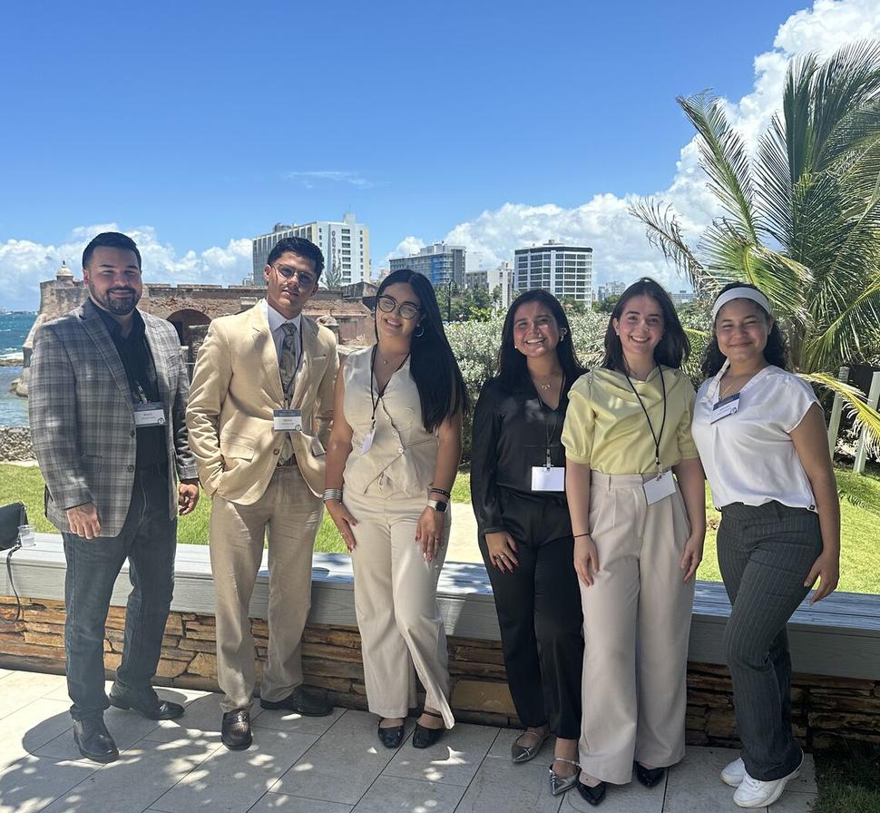 Workshop attendees smile for a picture outside the workshop.