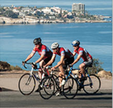 Three bicyclists cycling outside