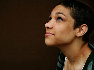 Young female looking up with hope