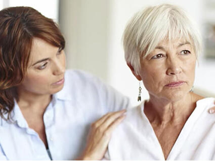 Young woman comforting an older worried woman