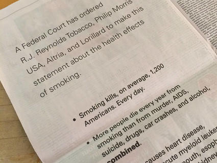 A photo of a newspaper page with text that includes a court ordered statement from major tobacco companies along statistics abou the negative health impacts of smoking.