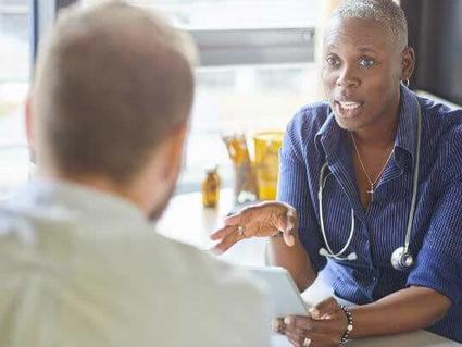 A female doctor speaking with a male patient.