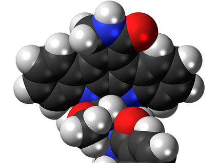 3D molecular model of midostaurin, an FDA-approved drug for treating certain patients with acute myeloid leukemia, showing black carbon atoms, white hydrogen atoms, blue nitrogen atoms, and red oxygen atoms connected in a complex molecular structure.