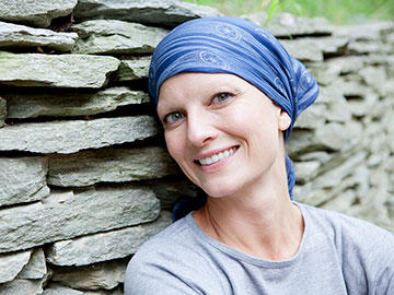 Smiling woman wearing head scarf.