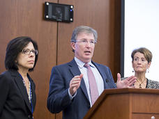 The co-chairs of the Blue Ribbon Panel stand before a lectern