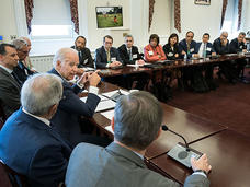 VP Biden speaks to panelists who sit at tables