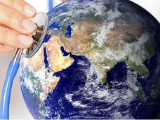 A composite image showing a hand holding the bell of a stethoscope to a satellite image of the planet earth. The side of the planet is focused on the contents of Africa, Europe and Asia.