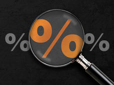Photo of a magnifying glass over an orange percentage sign 