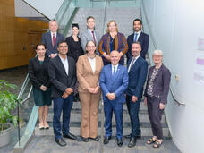 Group of WHO and NCI colleagues standing together on a set of stairs 
