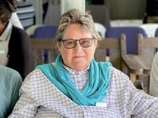 Lyn Denny sitting in a chair