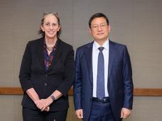 Dr. Kimryn Rathmell and Dr. Seogyoun Kang standing together in front a table.