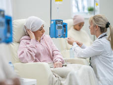 Young adult cancer patient talking with doctor