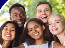 Image of two teenage boys and three teenage girls standing together in a circular shape, smiling.