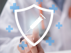 Clinician sits behind a laptop. Above the laptop is the emblem of a shield, surrounded by blue crosses. A syringe is superimposed on the shield and the doctor is pressing the emblem with his finger. Denotes how AI is helping doctors select treatment for their patients.