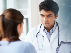 Doctor shows a colleague clinical data on a tablet.