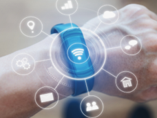 Image of a wearable device on a wrist with technology icons coming out.