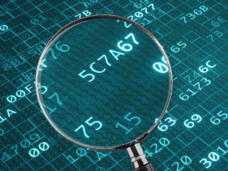 Magnifying glass over letters and numbers.