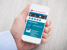 Hand holding a cell phone viewing the National Cancer Institute website