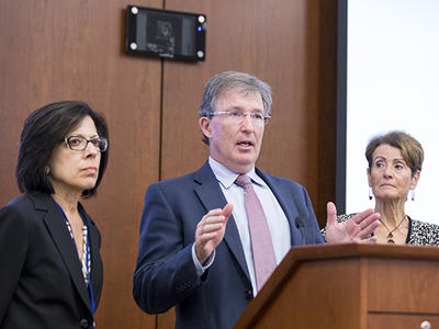 The co-chairs of the Blue Ribbon Panel stand before a lectern