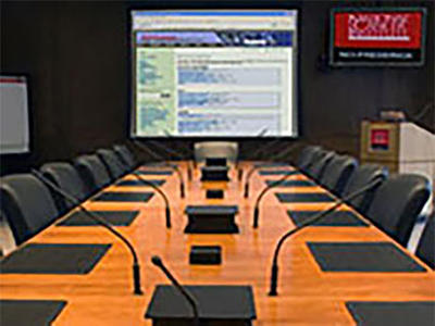 Conference table filled with microphones