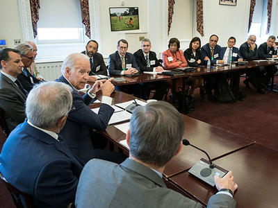 VP Biden speaks to panelists who sit at tables