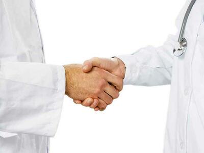Medical professionals shaking hands.