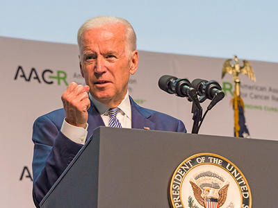 VP Biden speaks at a lectern with the Presidential seal