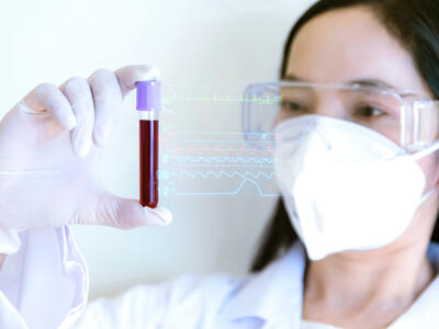 Female scientists with blood collection tube