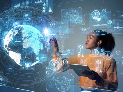 Black woman researcher in front of an image of the globe