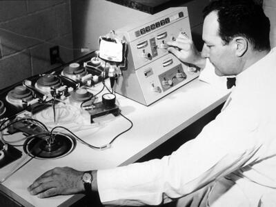 Emil Freireich working with a blood cell separator at MD Anderson Cancer Center.