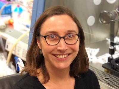 Photo of Dr. Ellen Langer next to a cell culture hood