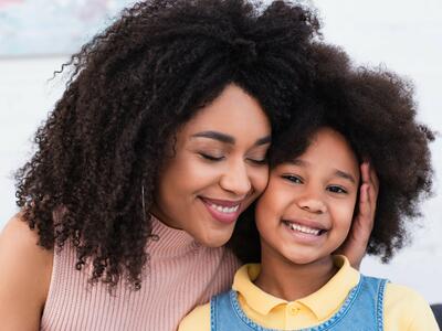 Image of smiling African American mother and child.