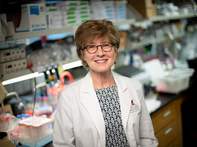 Photo of Dr. Suzanne Baker standing in her laboratory
