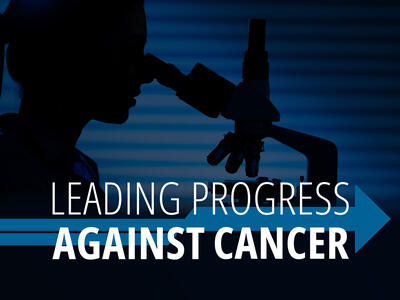 A silhouette of a scientist looking into a microscope.