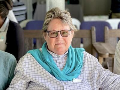 Lyn Denny sitting in a chair