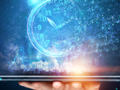 A hand is holding a tablet. Illuminating from the table is the image of a clock. This abstract image conveys how technology is helping monitor disease and predict the course of cancer over time.  