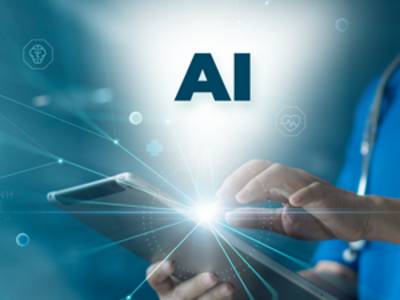 A person wearing a stethoscope holds a tablet with one hand and presses the screen with the other. The letters A-I are illuminated above the screen, depicting how doctors and researchers are using AI to address today’s biomedical issues.