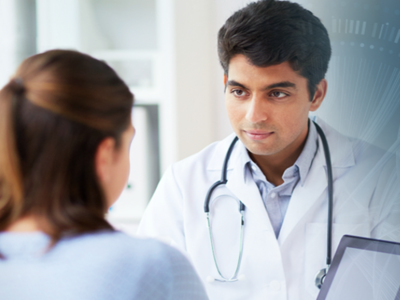 Doctor shows a colleague clinical data on a tablet.