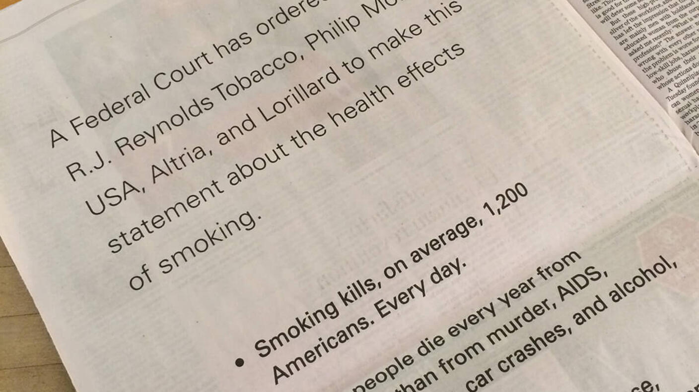 A photo of a newspaper page with text that includes a court ordered statement from major tobacco companies along statistics abou the negative health impacts of smoking.