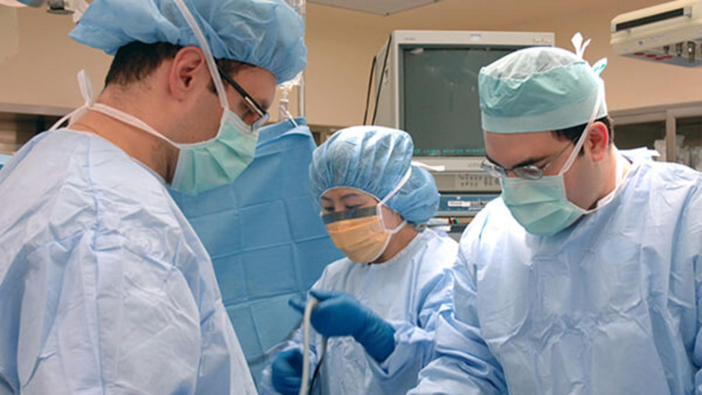 Group of surgeons in caps and masks.